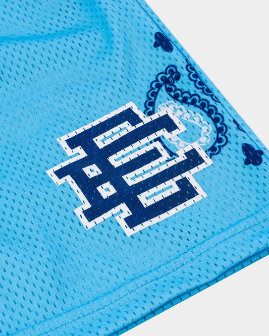 Close-up of blue designer athletic shorts for summer with printed navy logo and paisley pattern