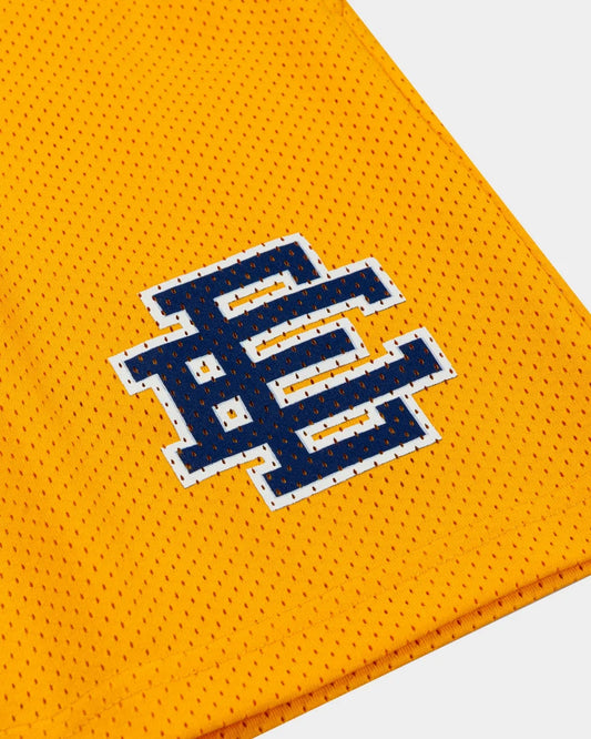 Close-up of yellow EE Basic mesh shorts fabric with stitched navy and white logo detail