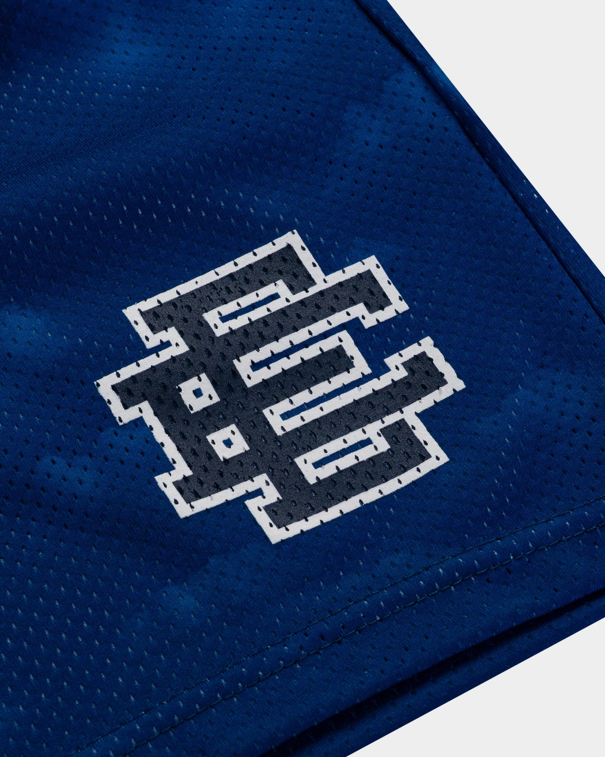 Close-up of EE Basic Navy athletic shorts showing breathable mesh fabric and logo detail