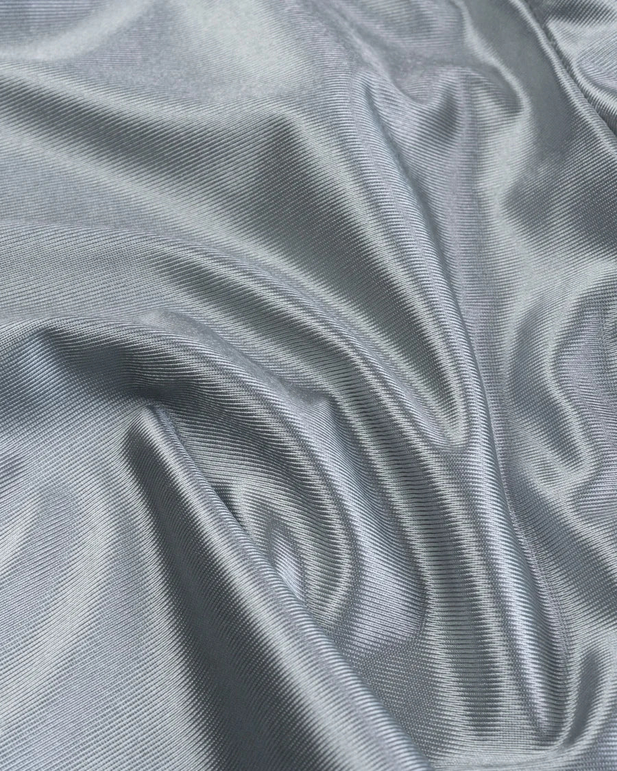 Close-up of gray fabric texture for premium baggy athletic shorts showing smooth and soft material